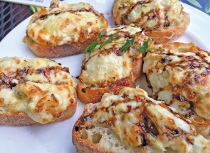 Bruschetta at Elderberry Pond is sliced from a crusty batard, larger than the traditional narrow baguette, topped with a warm mix of mozzarella, parmesan and artichoke hearts.