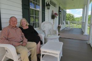 Bob Nezelek and his wife Lynda on the porch of their Another World Bed and Breakfast in Naples.