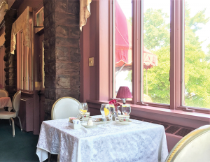Belhurst Edgar’s dining room: The stone walls, rich, dark wood and fine table settings evoked Victorian charm.
