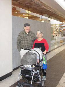 Tommy Cook and his wife, Cheryl, wheeling 11-month-old Ada Coyne, at Eastview Mall in Victor recently.