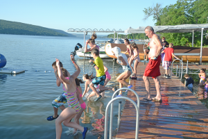 Campers at Camp Good Days and Special Times jump into Keuka Lake in Branchport