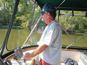 Jay Rodman, of Lakeville, at the helm of Cat's Meow. He, his wife and their friend Rob Hall took a 7,000-mile trip around the inner waterways of eastern North America.