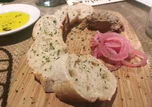 Rich duck liver pate, served with pickled red onions and sliced baguette. 