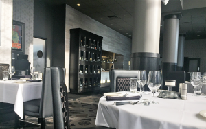 The restaurant has crisp, elegant decor, an open kitchen and large displays of wine. 