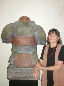 Nancy Jurs with a sculpture from her “armor” series