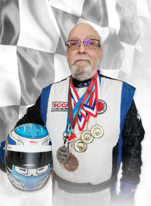 Auto racer Mark Green at his home in Avon, sporting some of the medals he has earned during his career. Photo provided.
