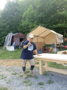 Michael Matteo at his Steuben County home with tables he built himself.