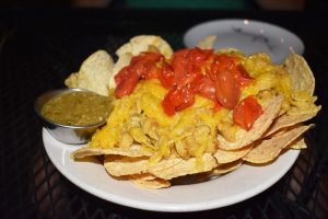 The mac and cheese nachos ($10.50) with chips and green olive salsa verde.