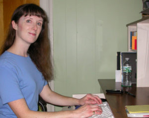 Writer Deborah Sergeant working at her workstation at home. She has worked from home for 20 years and share some tips on how to be successful and productive.