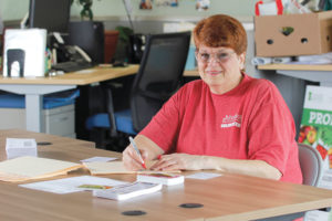 Debbie Leipold has been a volunteer for six years — and 848 shifts — at Foodlink. She works in a break room, preparing thank-you letters for people who donate money to the organization. 