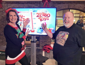 Rebecca Leclair and Gary the Happy Pirate reveal the total number of toys collected during 2019 Toy Drive-- 21,980.