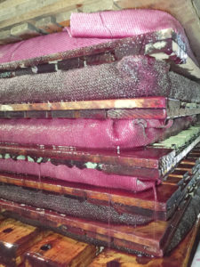 Pressing grapes’ process: The bundled, crushed grapes are stacked in a hydraulic wine press that squeezes out all the juice.