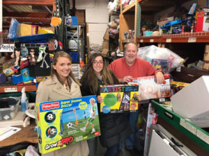 Gary the Happy Pirate with Marissa Andris and Jessica Roth dropping off toys collected at a holiday toy drive at their company, ConServe in 2016.