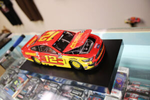 Nascar model. This is a model of Randy Blaney’s No.12 Advance Auto Parts car. Bench Racing Diecast Models & Collectibles shop owner Keith Still has just taken it out of the box and is inspecting it to make sure his customer gets exactly what he ordered.