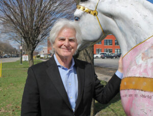 Howie Jacobson, with the horse at the Breast Cancer Coalition of Rochester, honoring warrior women and designed by artist Hollis Biggs Garver. 